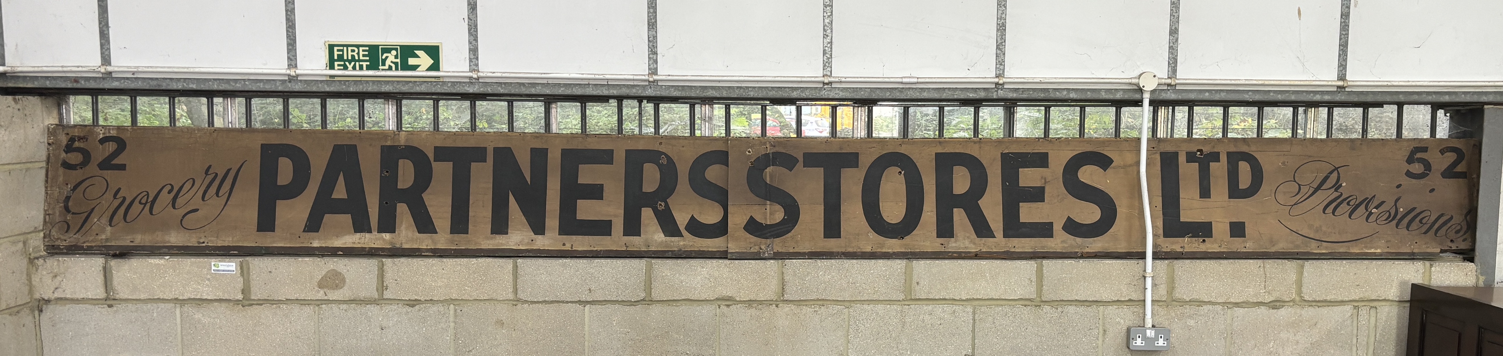 A vintage Partners Stores Limited shop sign, combined length approx. 540cm, height 44cm